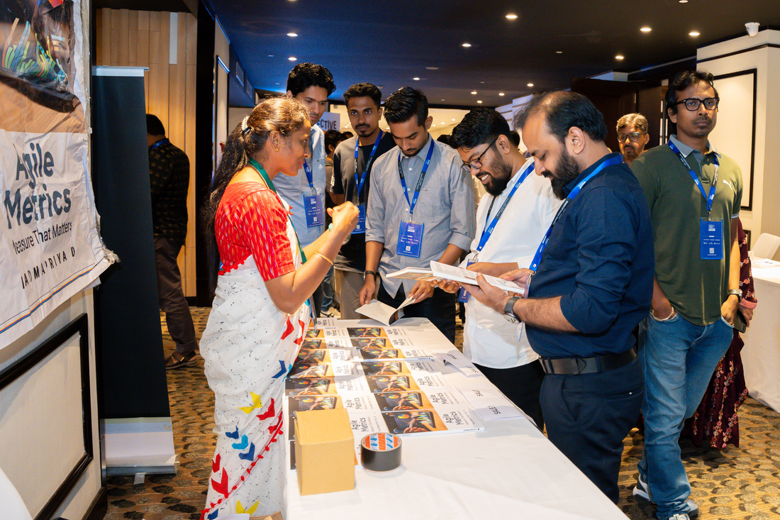 A speaker on stage at an Agile Bangladesh event